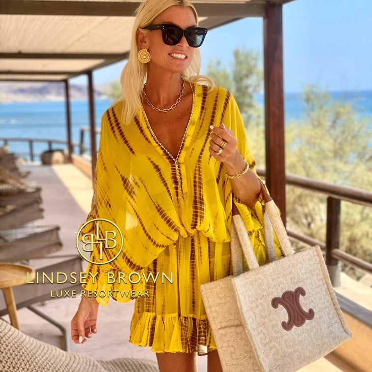 Yellow silk bloused drop waisted silk kaftan to wear on holiday by Lindsey Brown resort wear seen on Anna Mavridis 